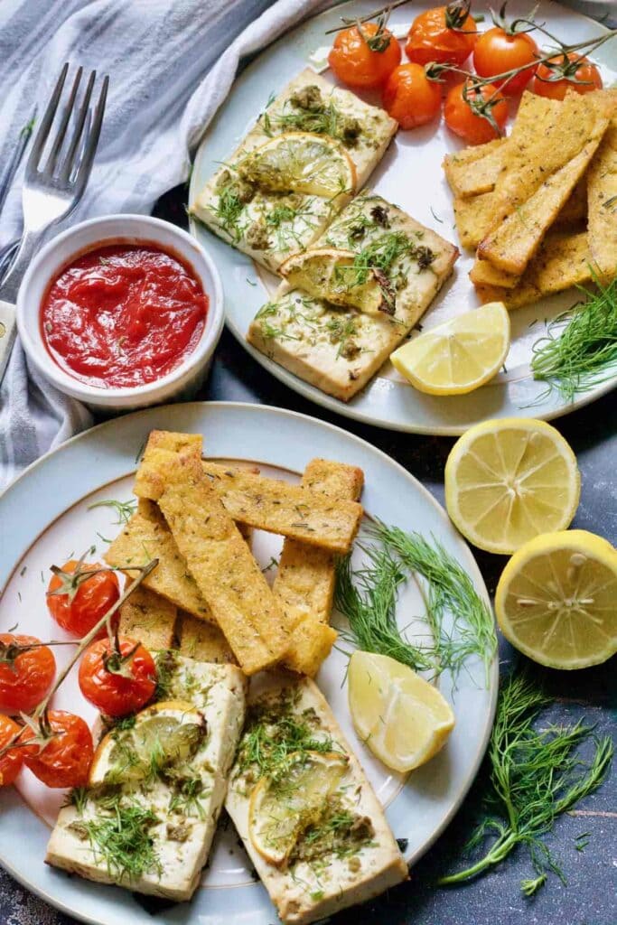 Two plates with served vegan tofu fish & sides.