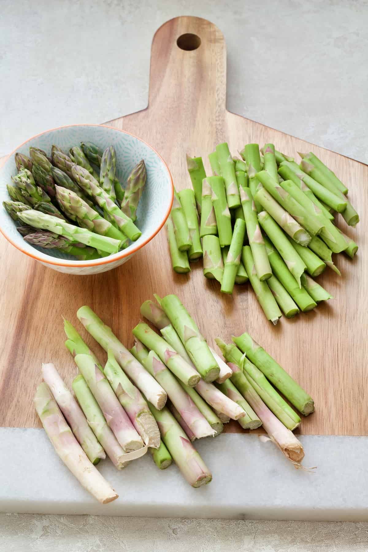 Prepared asparagus on wooden board.