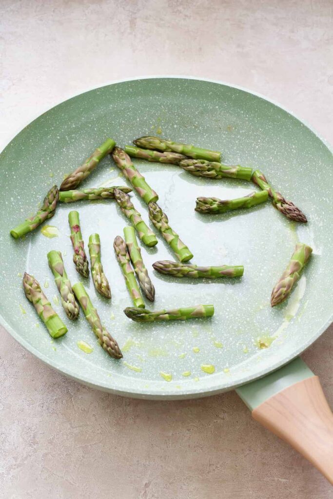 Asparagus tips in the frying pan.