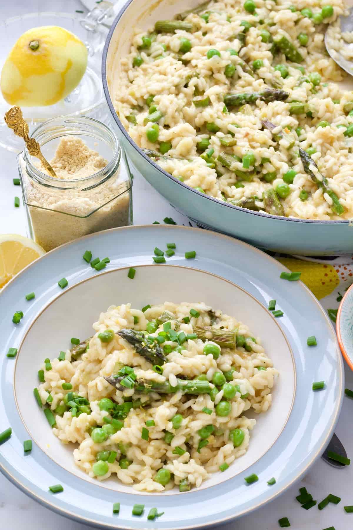 Portion of risotto in a bowl with full pan behind it.