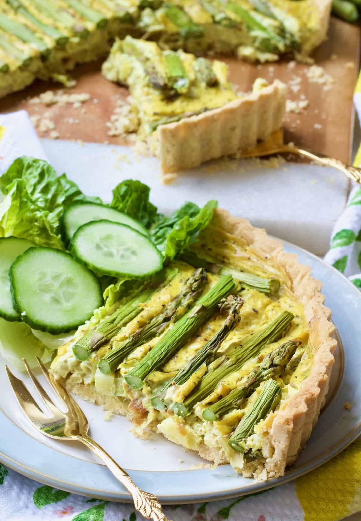 Slice of vegan quiche on a plate with garnish.