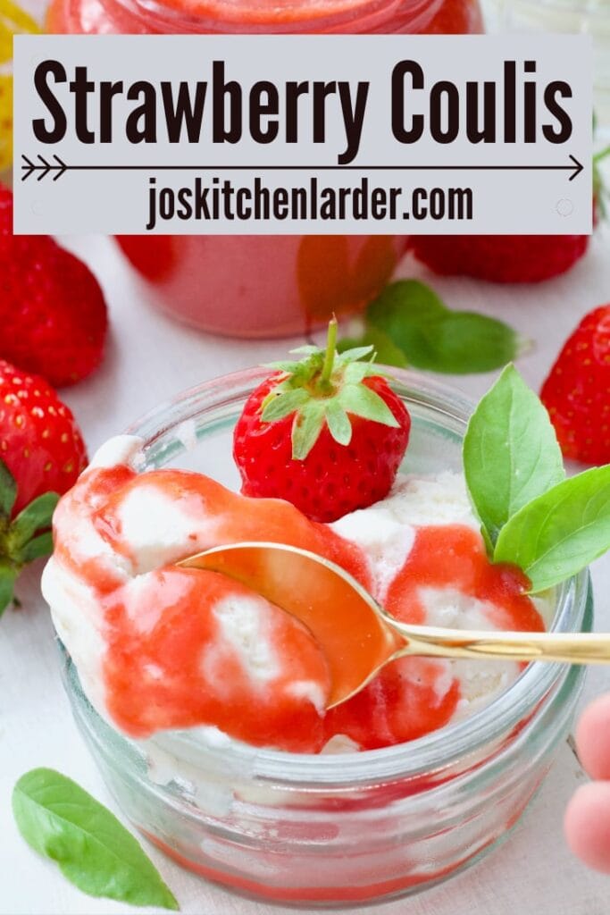 Spoon digging into ice cream with strawberry coulis.