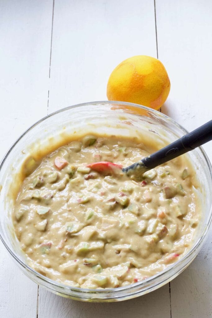 Ready rhubarb muffin batter in a bowl.