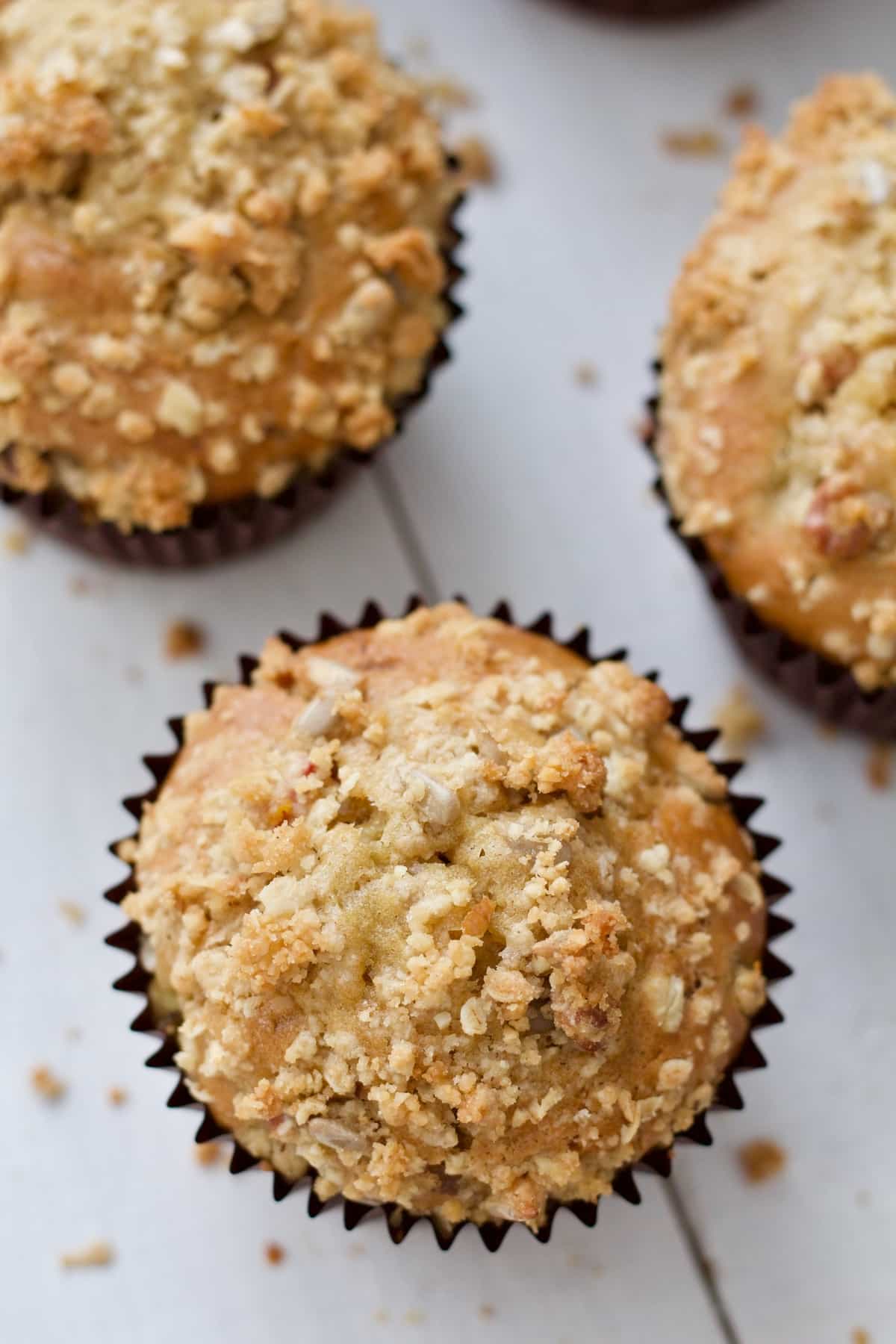Close up of a top of a muffin showing crumble topping.