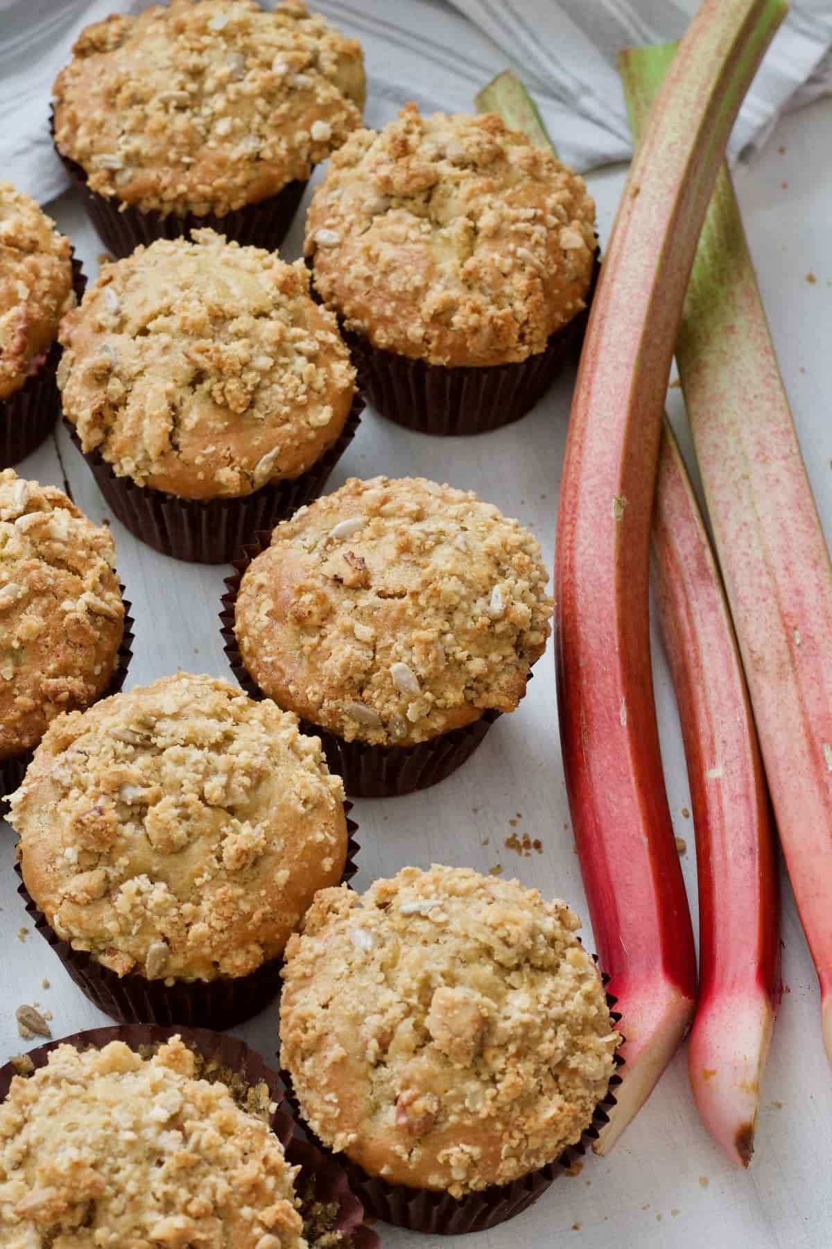 Rhubarb muffins with rhubarb stalks on the side.