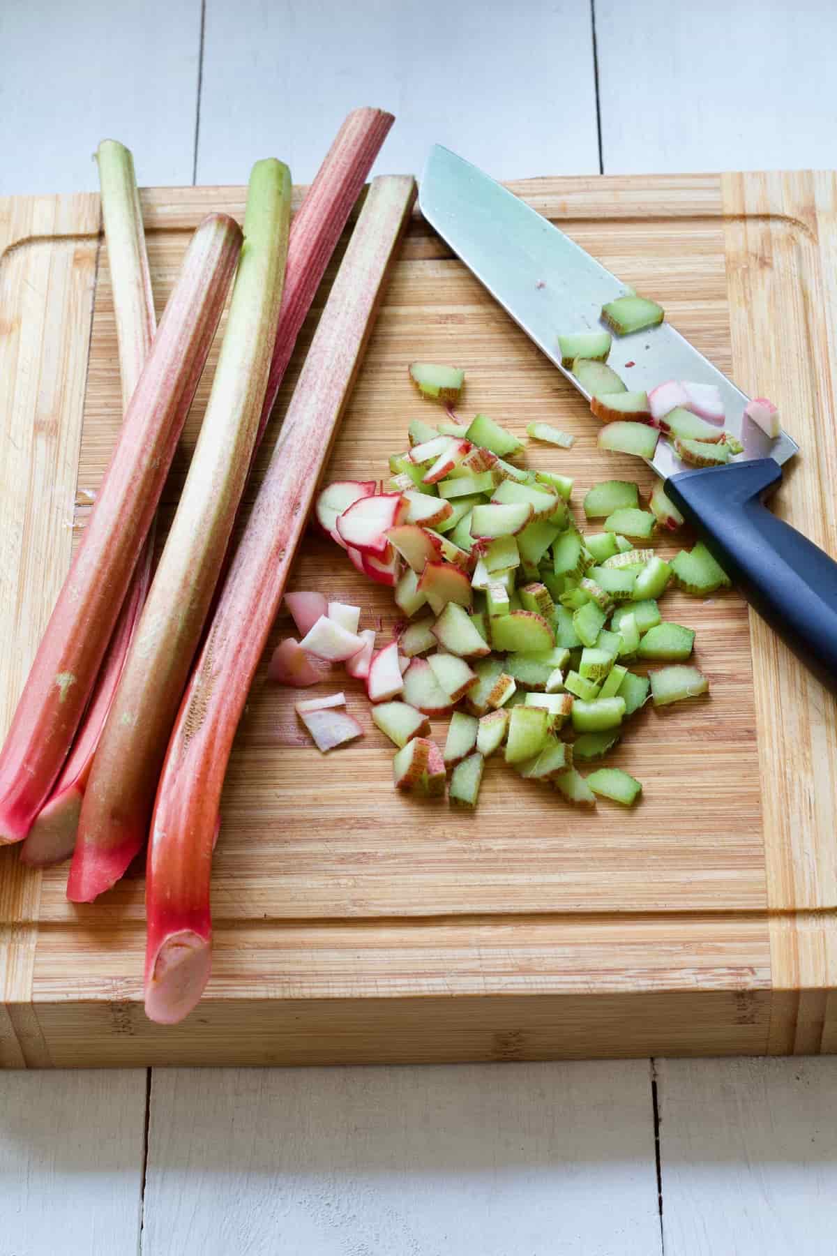 Partially chopped rhubarb on the cutting board.