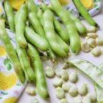 Broad beans in their pods and some podded.