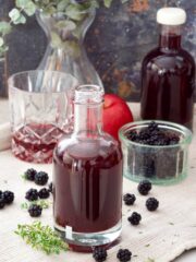 Blackberry vinegar, blackberries, tumbler, apple, vase.