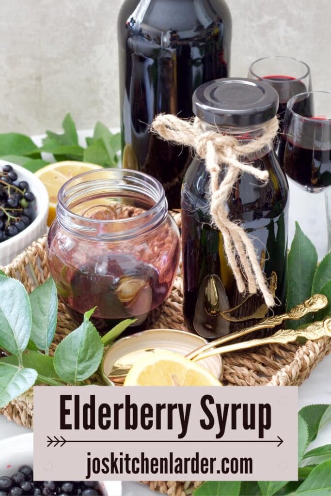 Jar & bottle with elderberry syrup in a wicker tray.