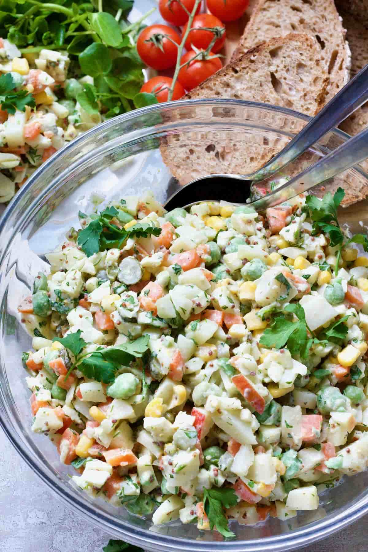 Russian Salad in a bowl with spoons.