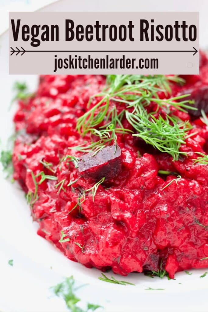 Close up of beetroot risotto with chunks of beetroot and dill.