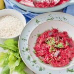 Serving bowl with portion of beetroot risotto.