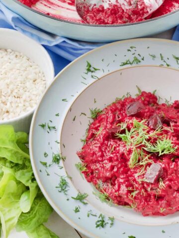 Serving bowl with portion of beetroot risotto.