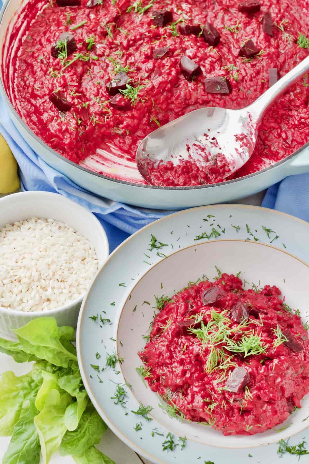 Pan with beetroot risotto and portion in a serving bowl with dill garnish.