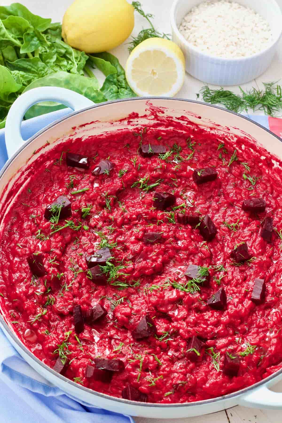 Pan with beetroot risotto garnished with dill.