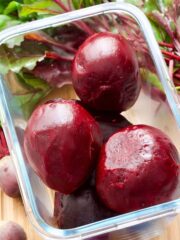 Cooked and peeled beetroot in a glass container.