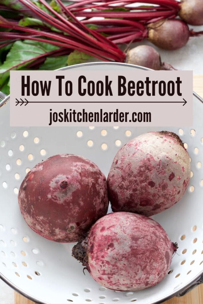 Three boiled beets in a colander.