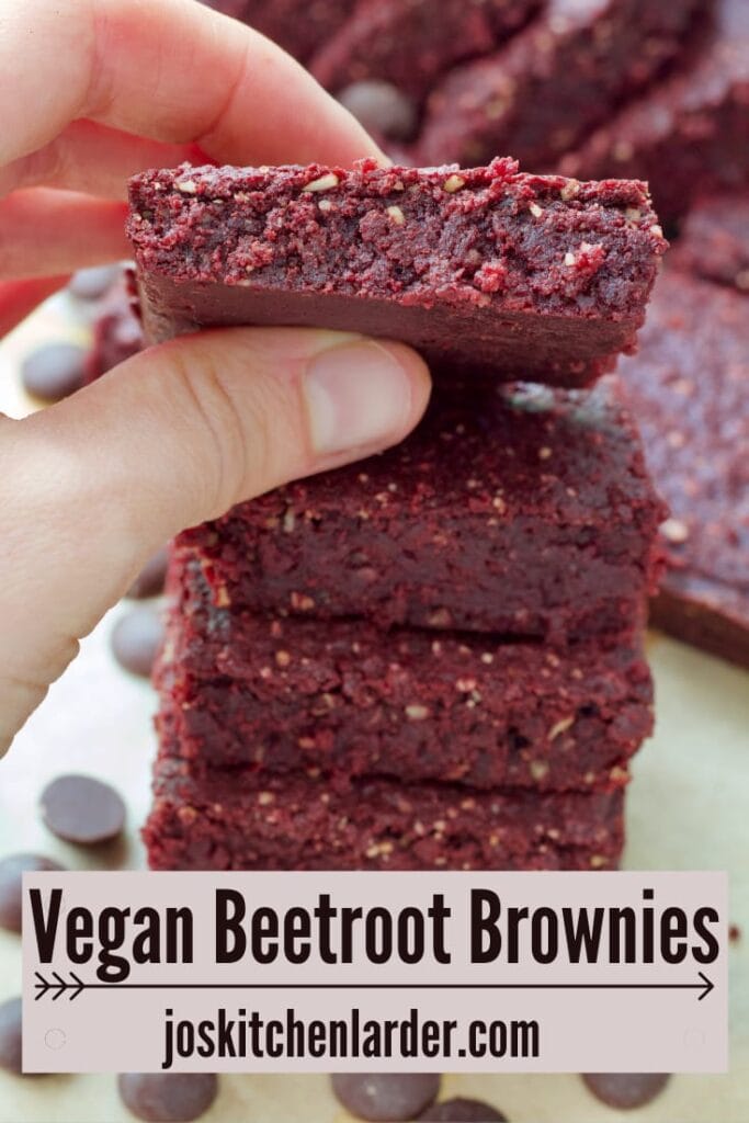 Hand holding vegan beetroot brownie.