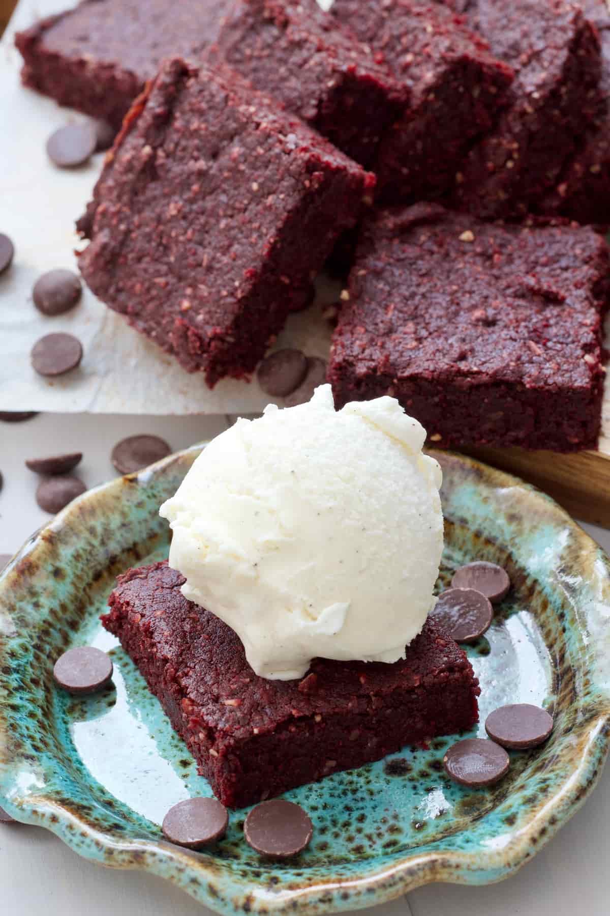 Vegan beetroot brownie served with scoop of ice cream.