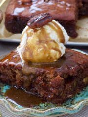 Vegan sticky toffee pudding close up, with ice cream and toffee sauce.