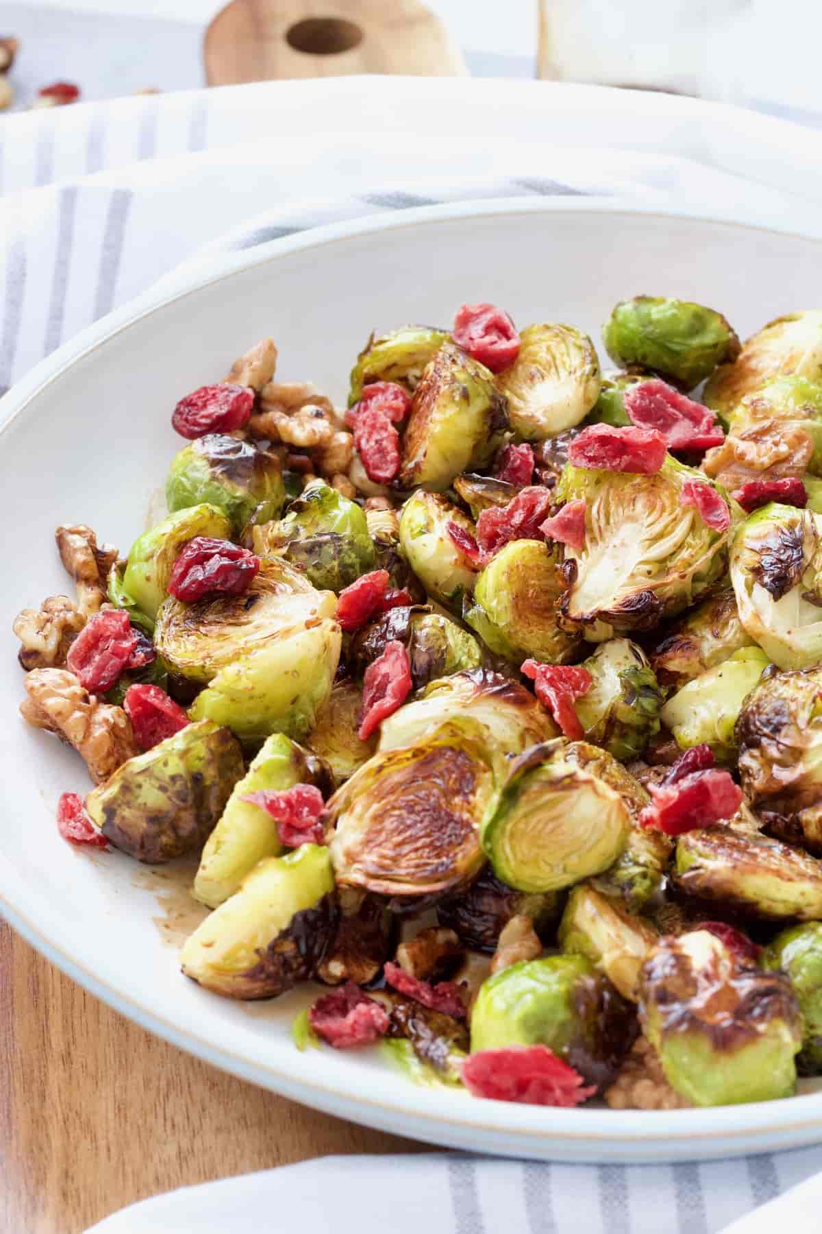 Close up of roasted Brussels sprouts topped with cranberries.