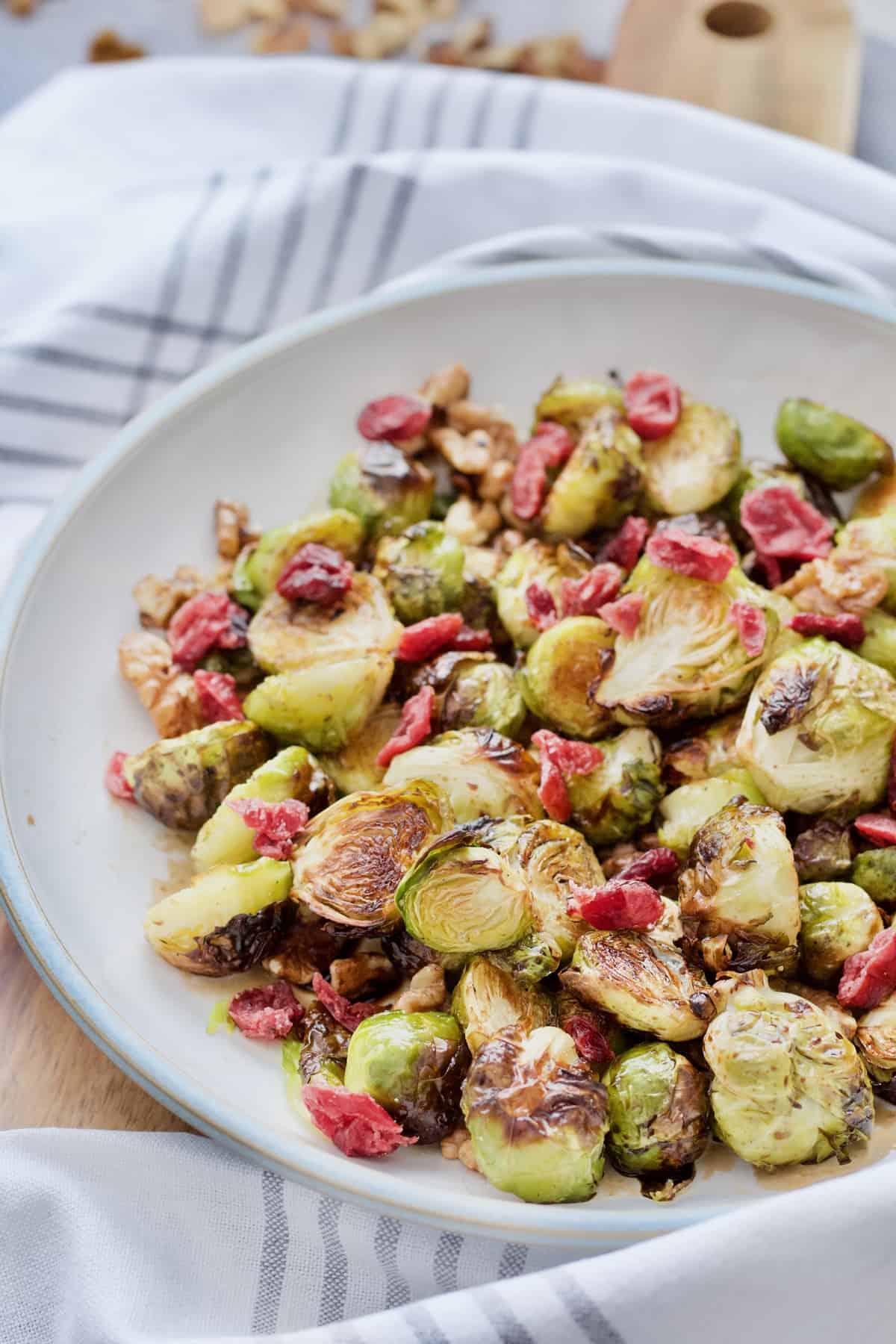 Close up of roasted Brussels sprouts topped with cranberries.