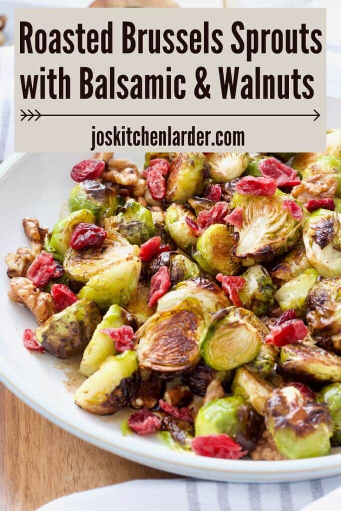 Close up of roasted Brussels sprouts topped with cranberries, image for Pinterest.