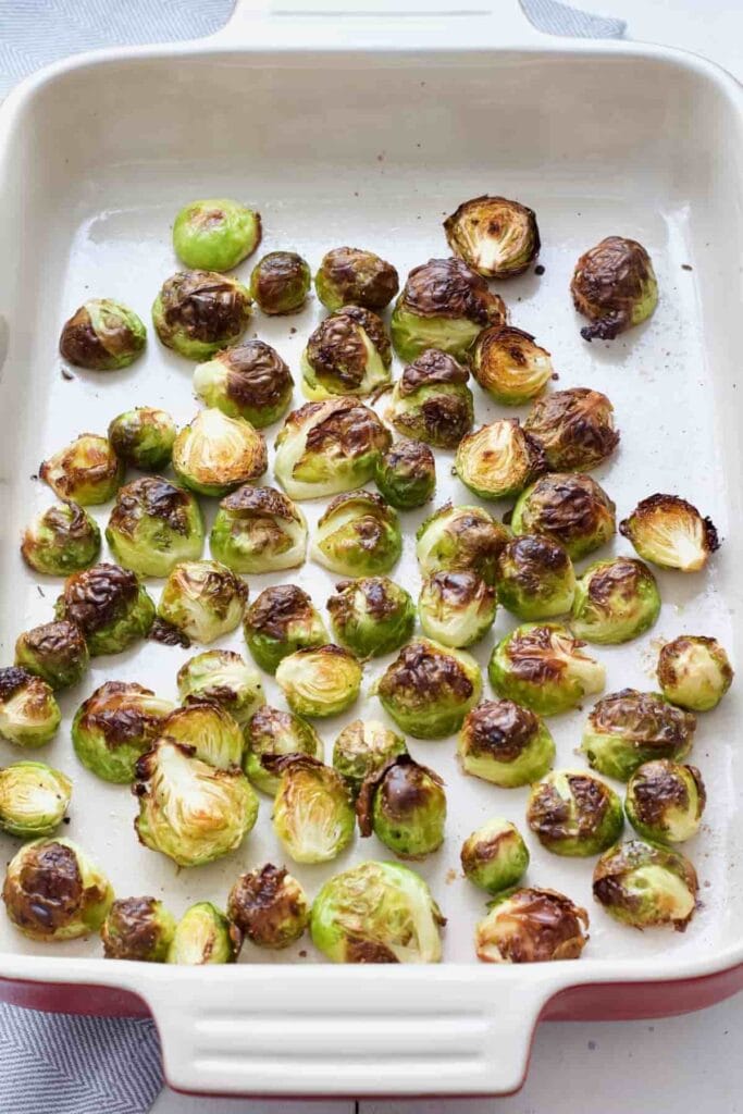 Roasted brussels sprouts in a baking dish.