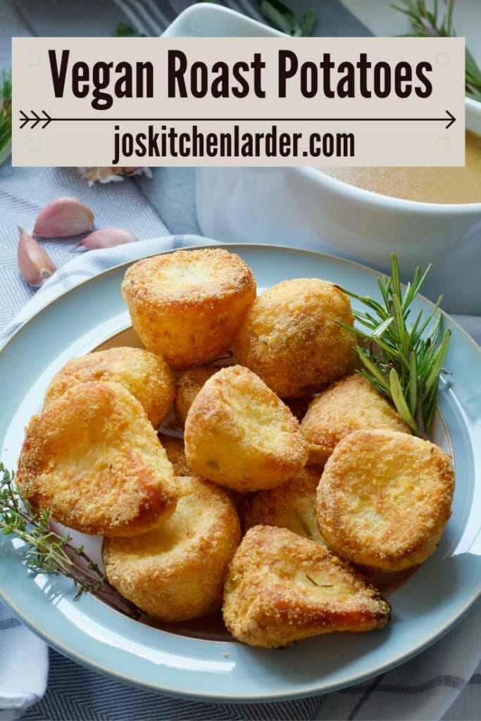 Vegan roast potatoes in a bowl with rosemary and thyme.