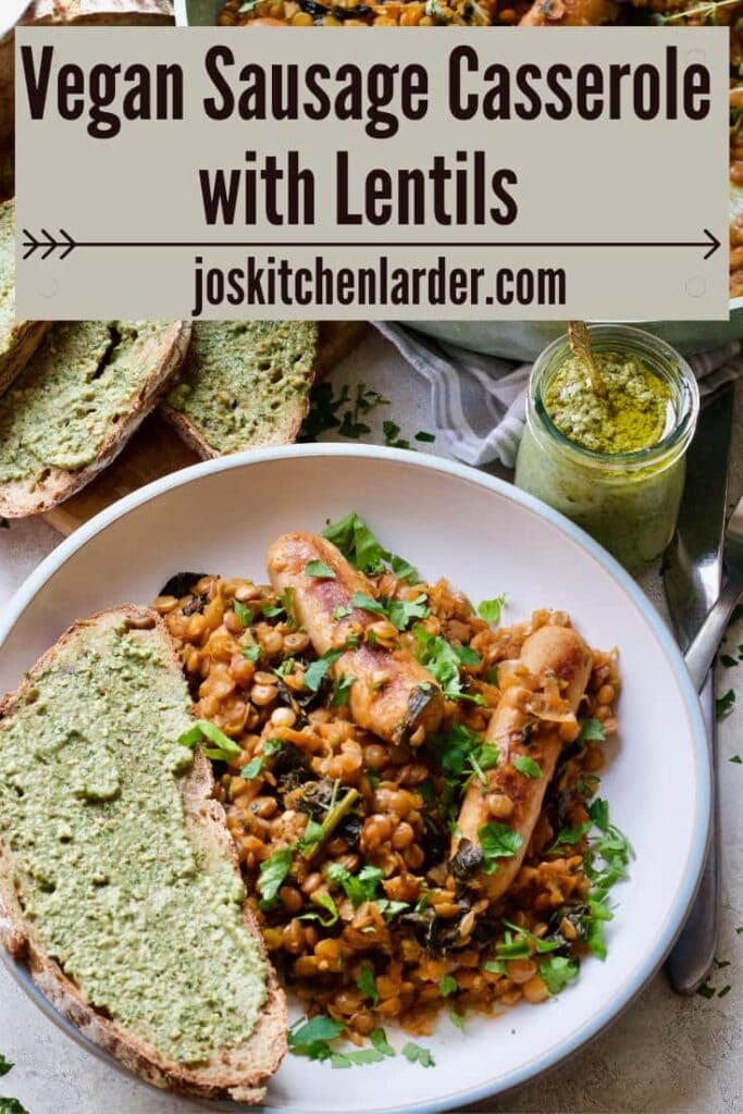 Plated up vegan sausage casserole with a slice of bread with pesto.