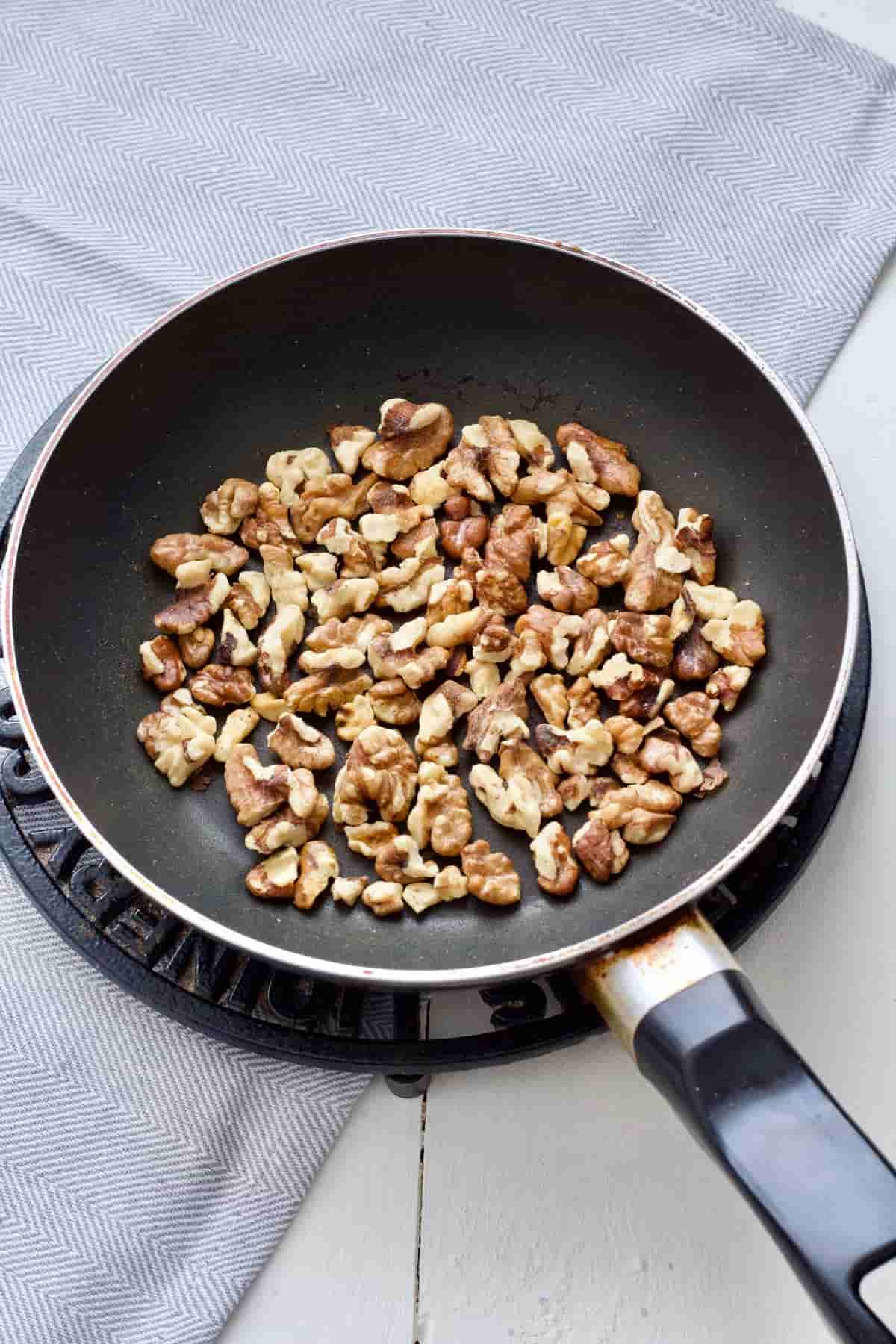 Walnuts in a frying pan.