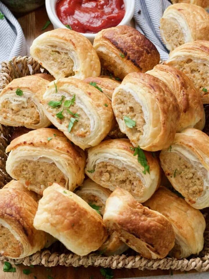 Vegan sausage rolls piled up in the basket.