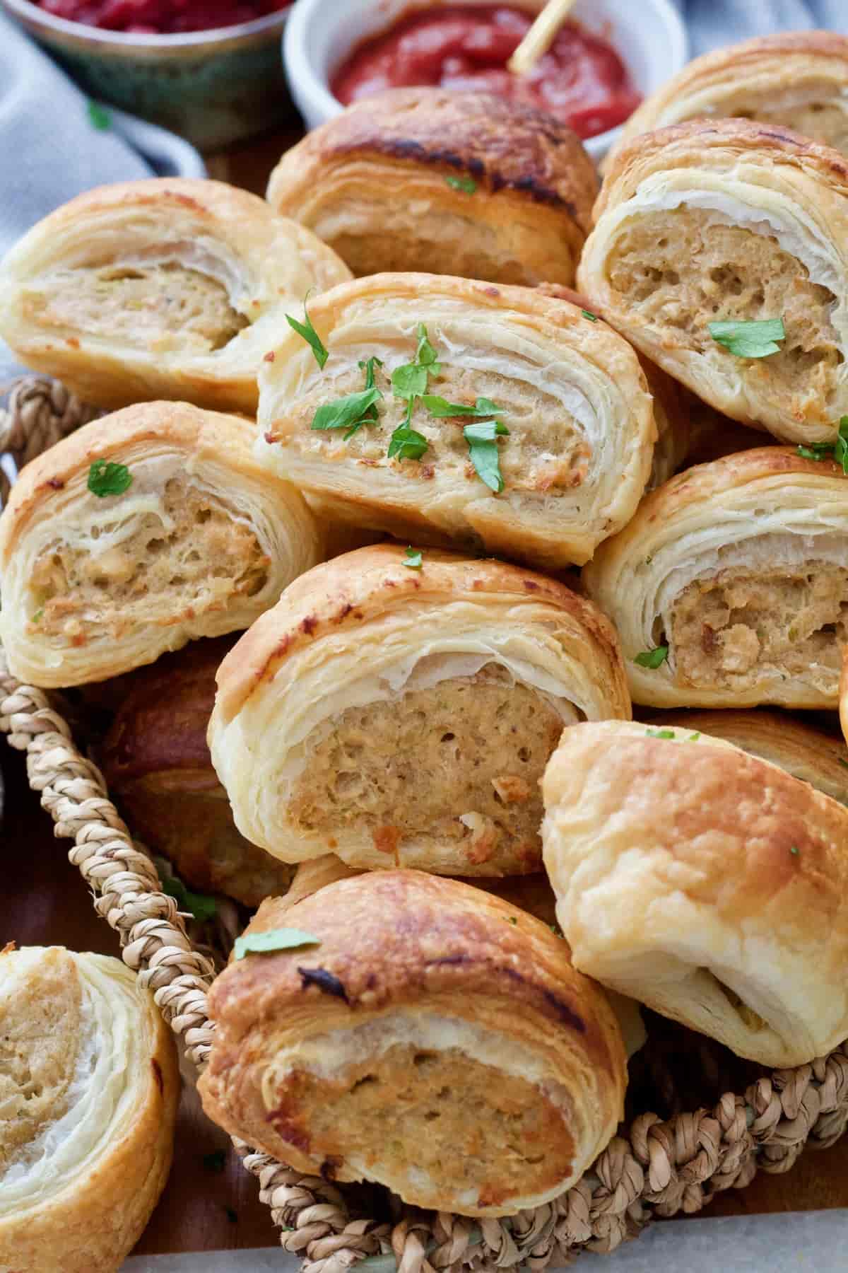 Close up of few sausage rolls neatly piled up.