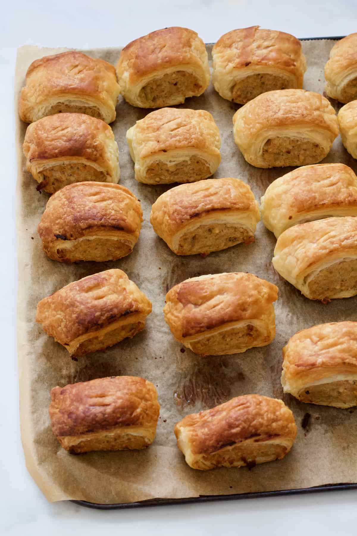 Vegan sausage rolls on baking sheet.