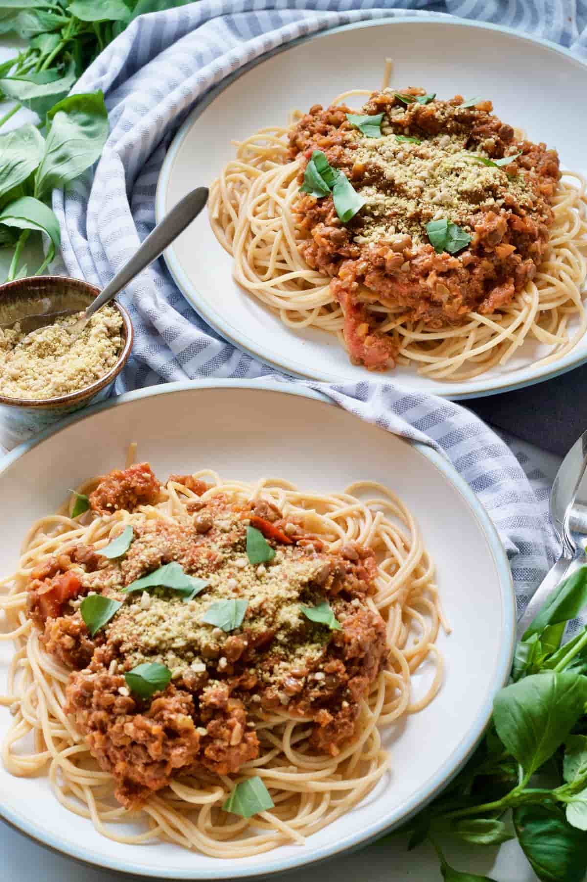 Two bowls with vegan spaghetti bolognese.