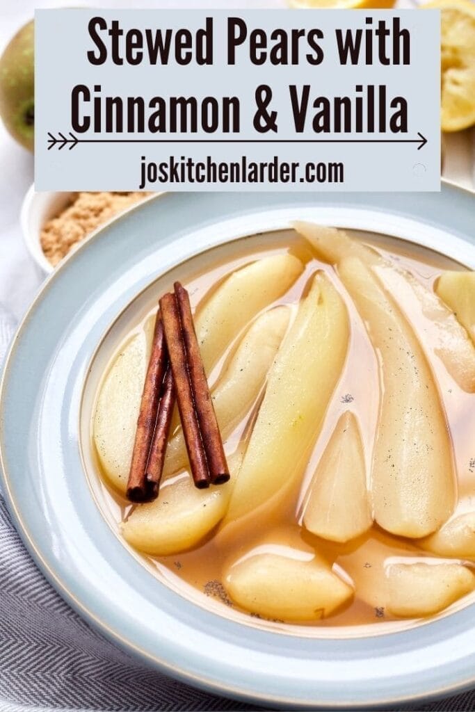 Stewed pears in a bowl with cinnamon sticks.