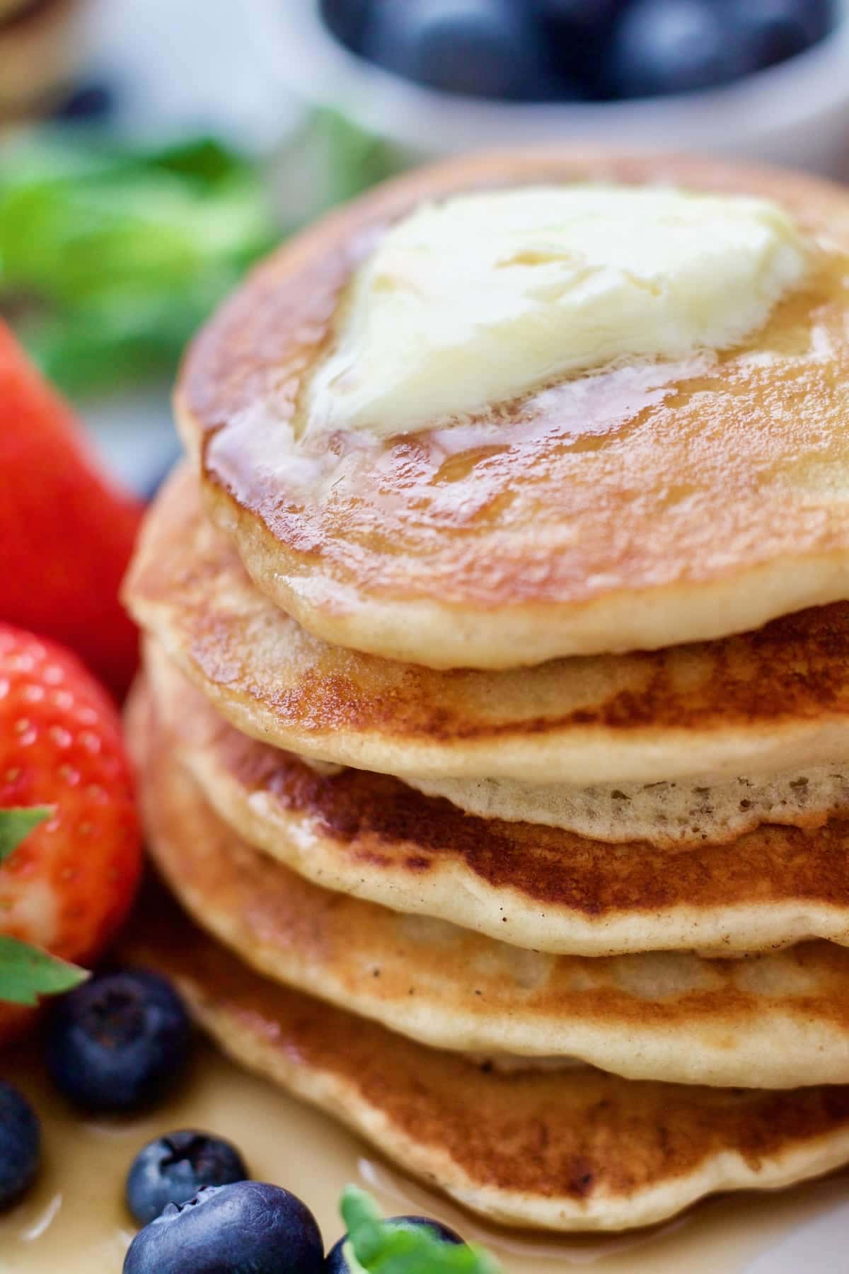 Close up of stack of vegan pancakes with melting vegan butter.