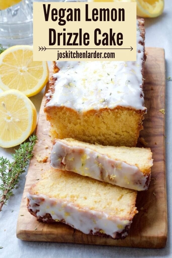 Iced vegan lemon drizzle cake on a board.