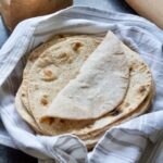 Close up of pile of chapatis with top one folded over.
