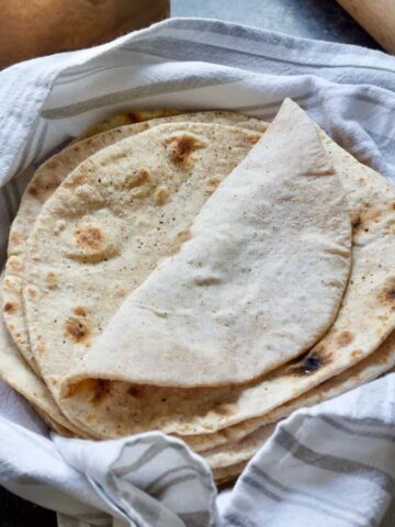 Close up of pile of chapatis with top one folded over.