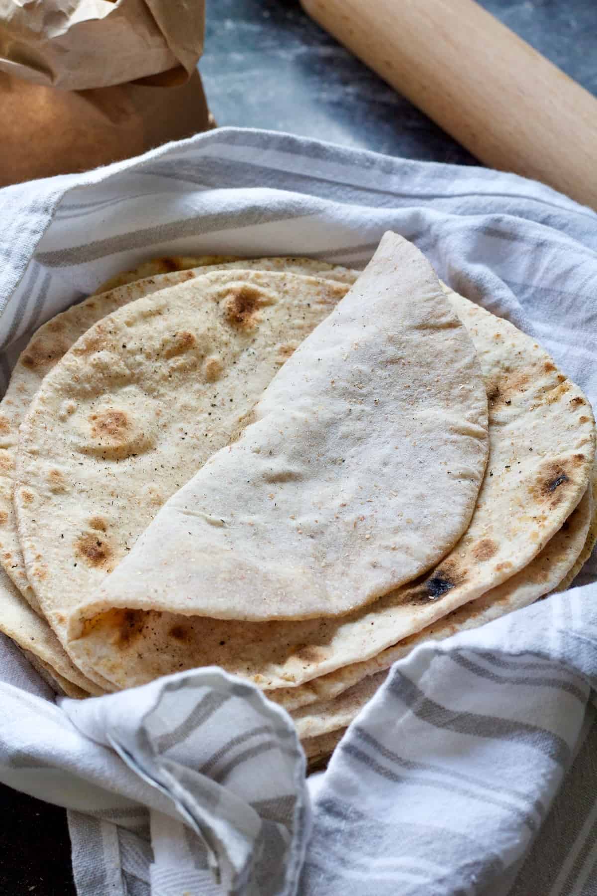 Pile of chapatis with top one folded over.