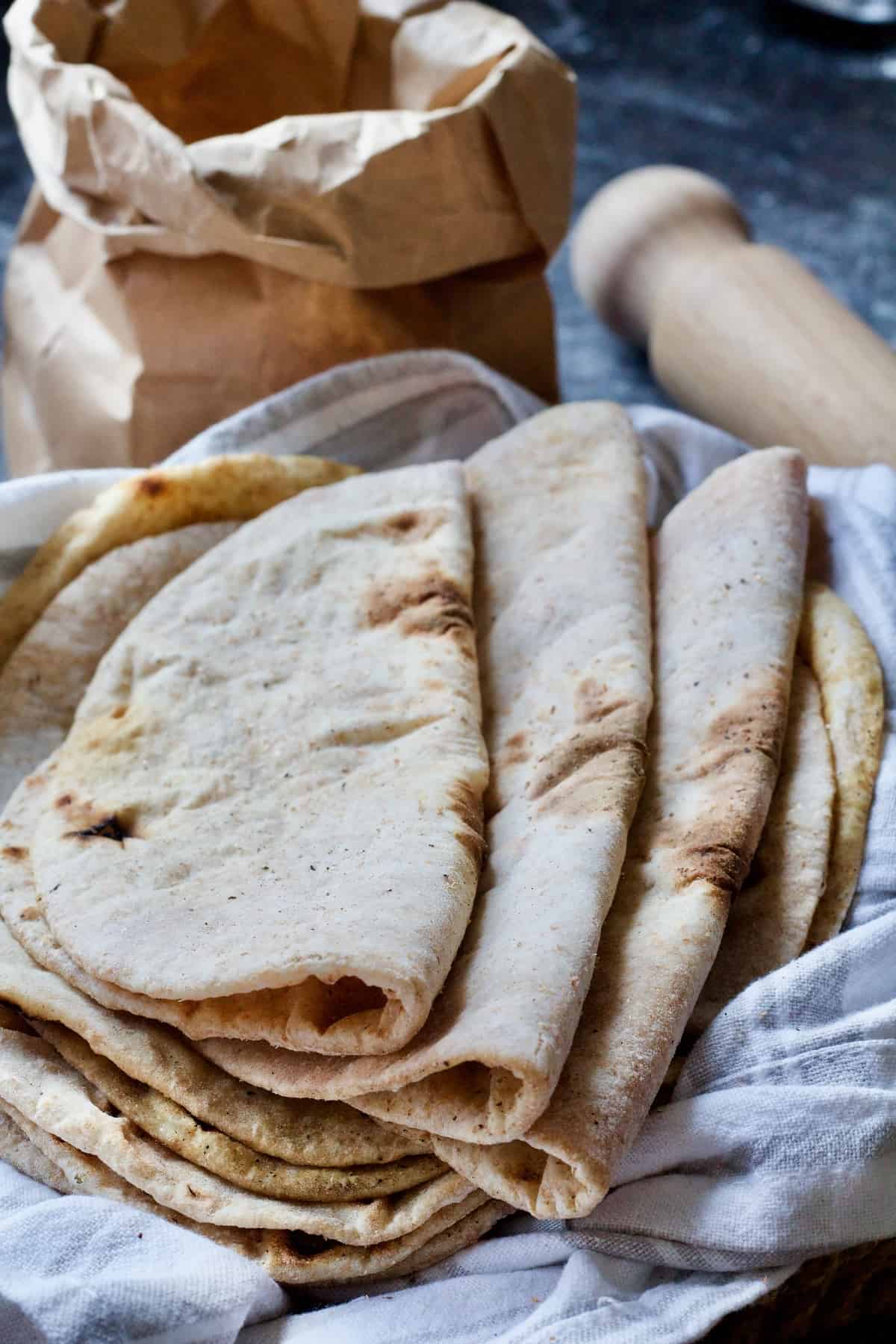 Folded flatbreads resting on a towel.