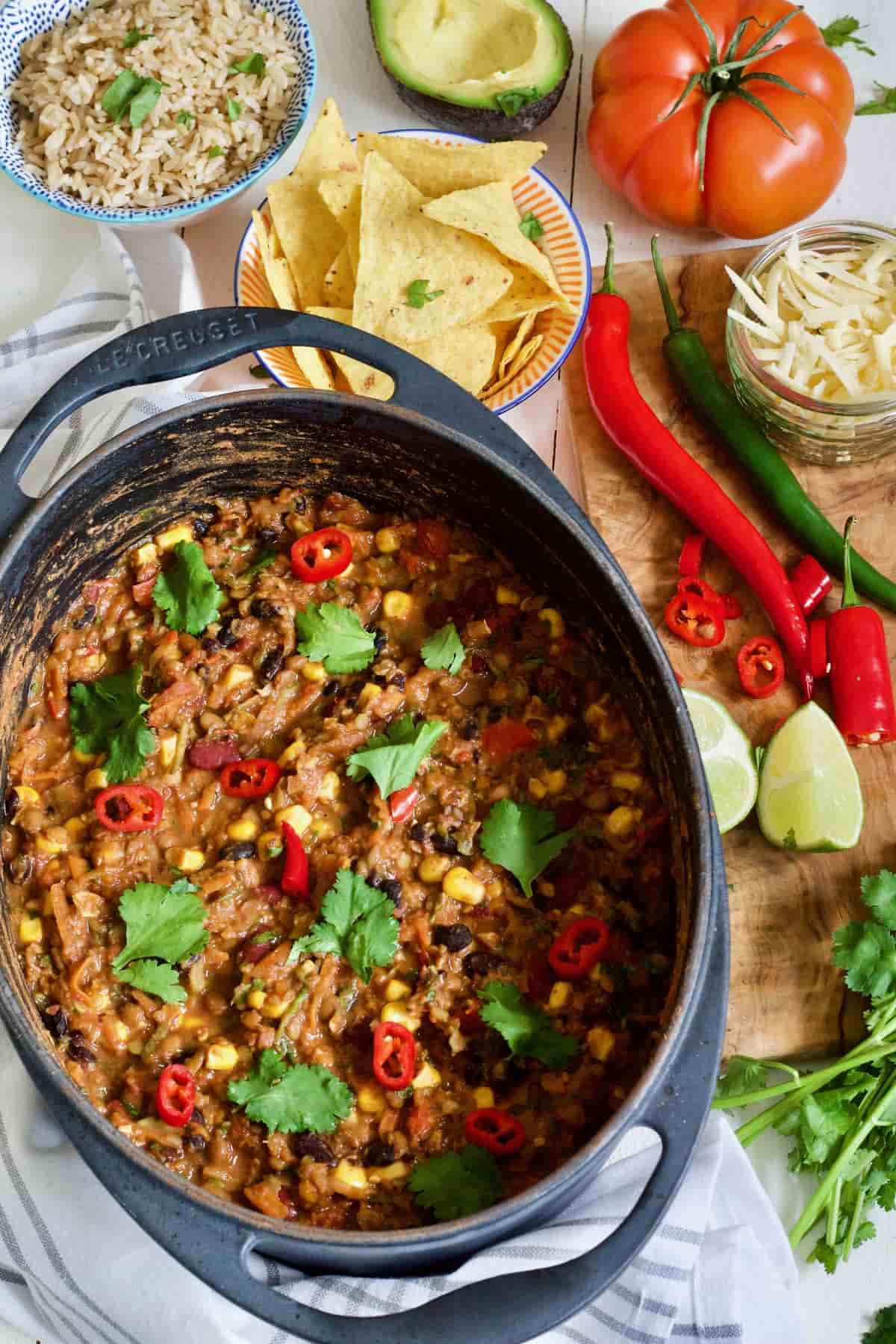 Large pot with chilli and toppings.