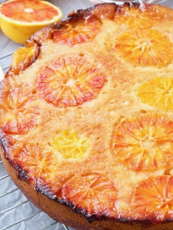 Vegan blood orange upside down cake on a cooling rack.