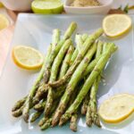 Air fryer asparagus bunch on serving platter.