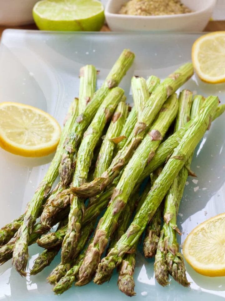 Air fryer asparagus bunch on serving platter.