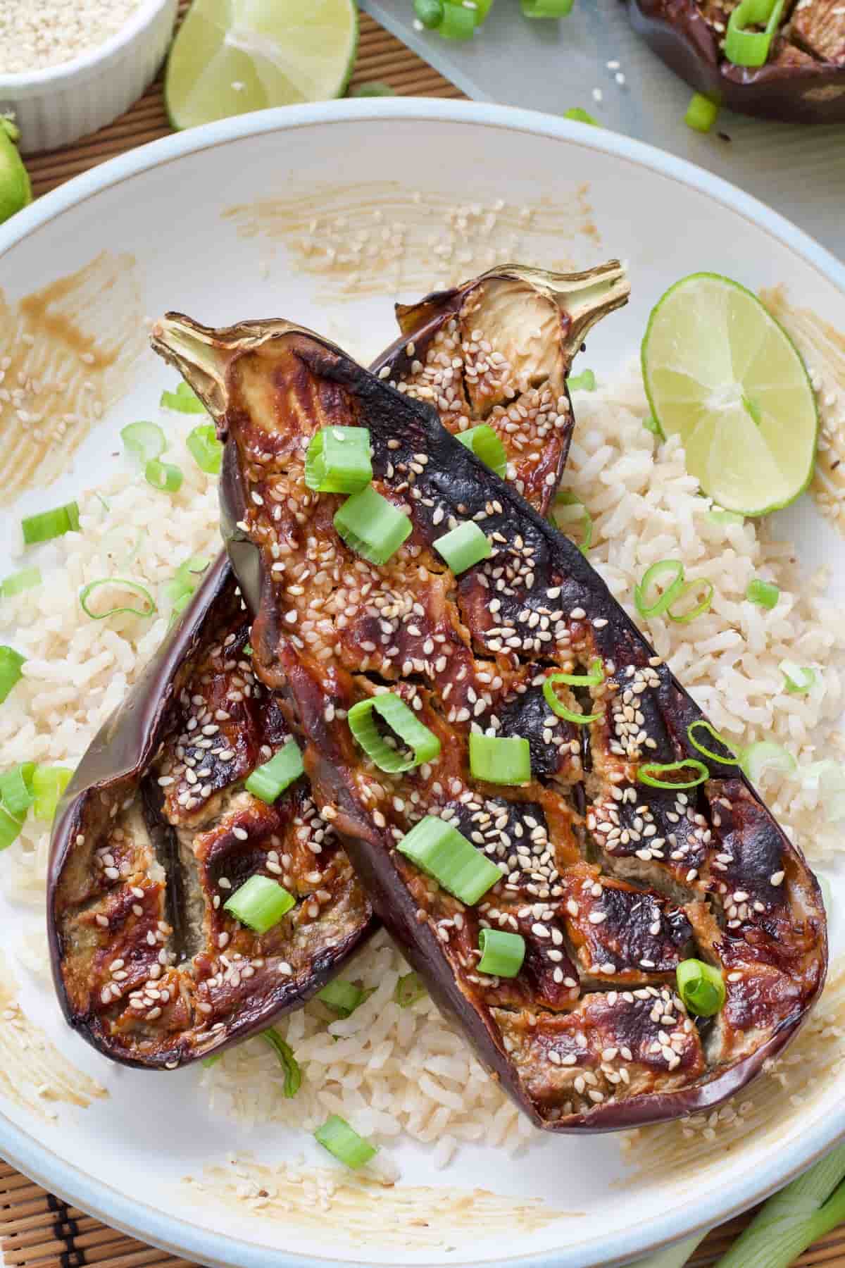 2 halves of miso aubergine on top of rice, spring onion slices on top.