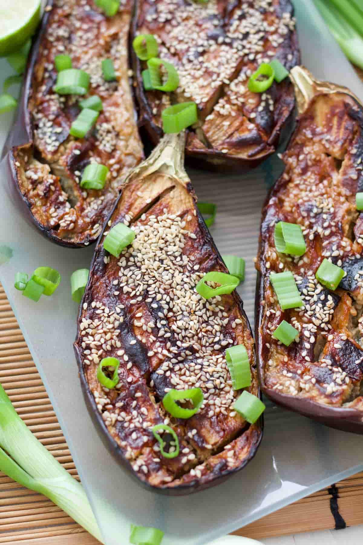 Close up of miso aubergine with sesame seeds and spring onions.