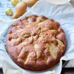 Pear and fresh ginger cake on a piece of parchment.