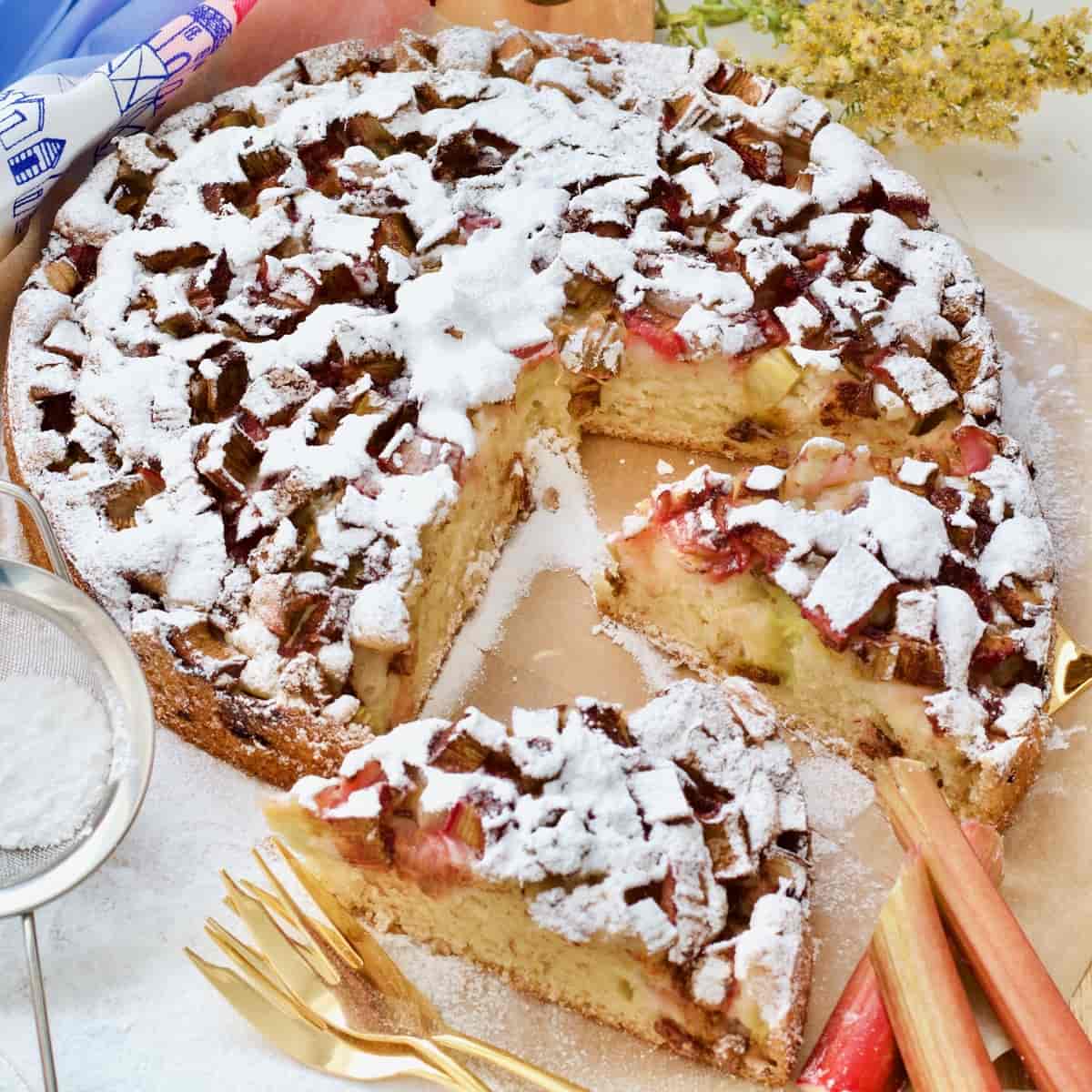 Easy rhubarb cake with two slices cut and ready to be served.